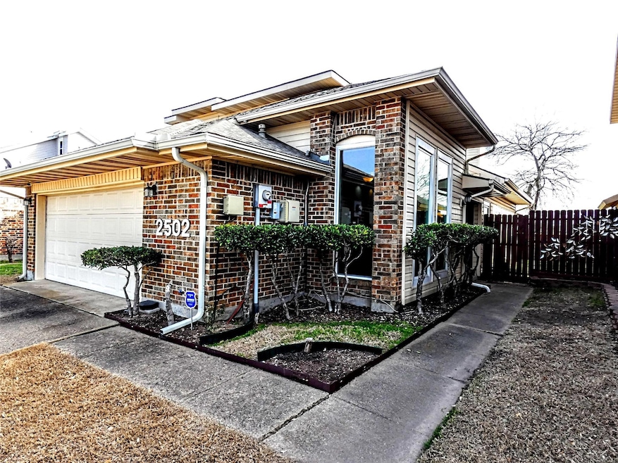 View of front of home with brick siding, an attach
