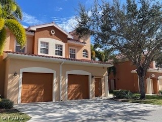 Mediterranean / spanish-style home with a garage