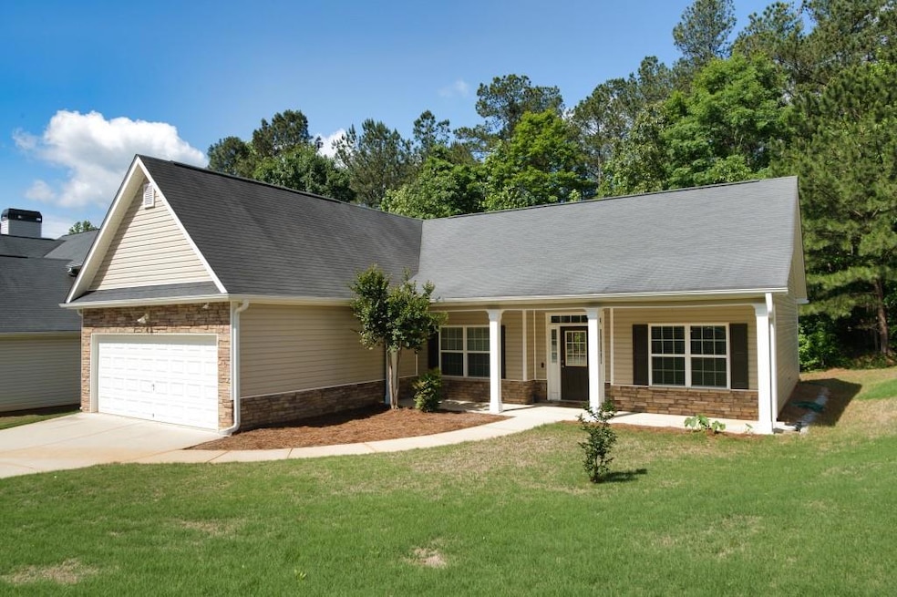 Ranch-style home with an attached garage, driveway