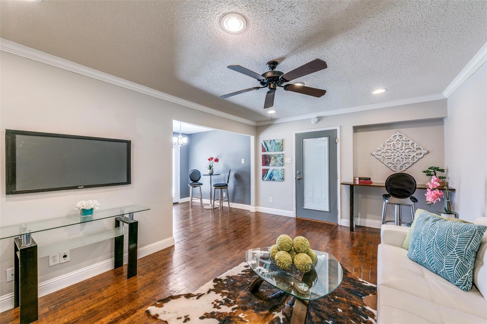 Living room with ornamental molding, ceiling fan, 