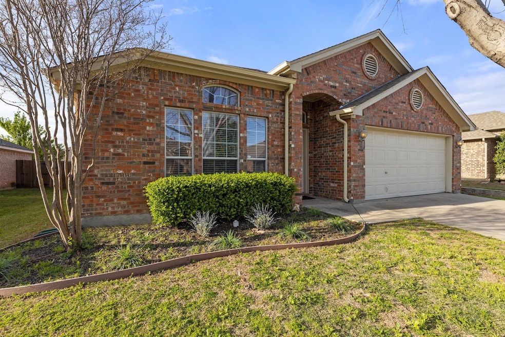 View of front of home with a garage and a front la