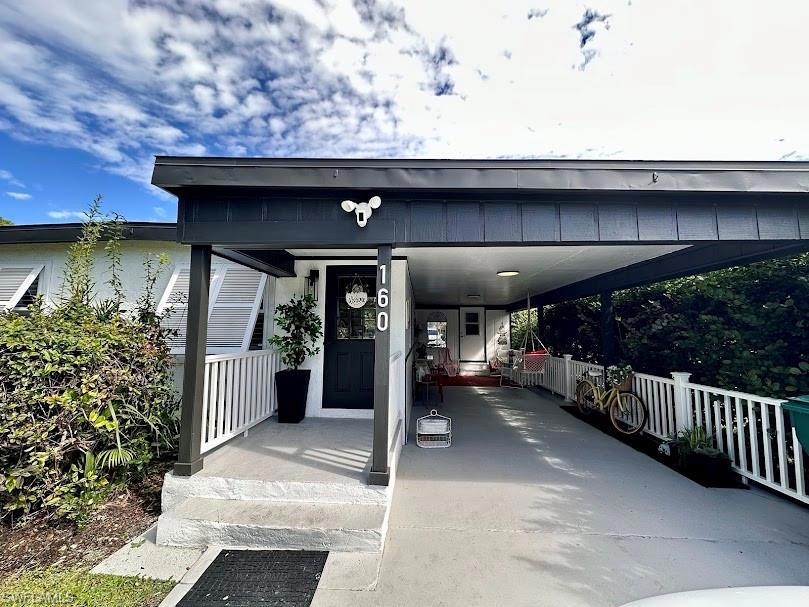Doorway to property with a carport