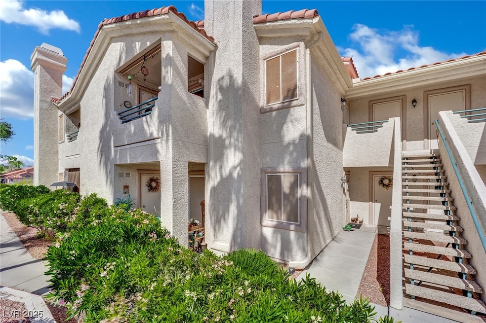 View of front of home featuring stucco siding, a t