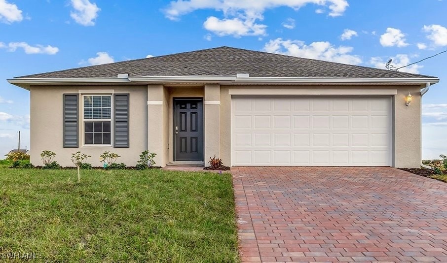 View of front of property with decorative driveway