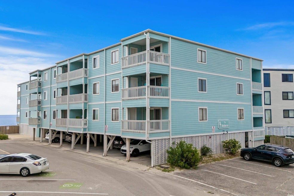 View of property featuring uncovered parking