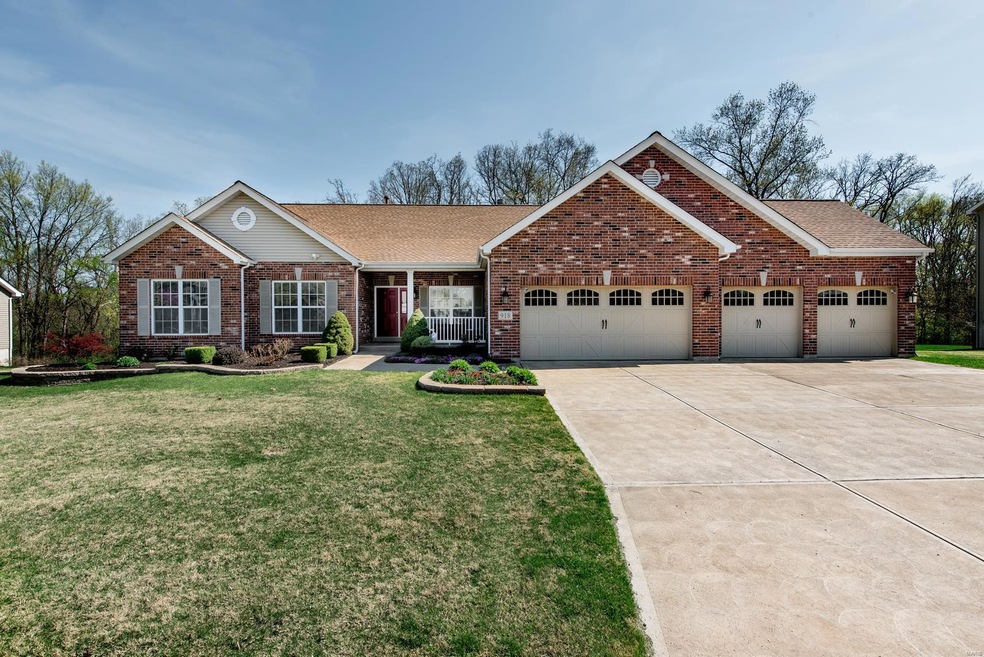 Gorgeous brick front home with a new roof, gutters and soffits (2018) and  4-car garage!