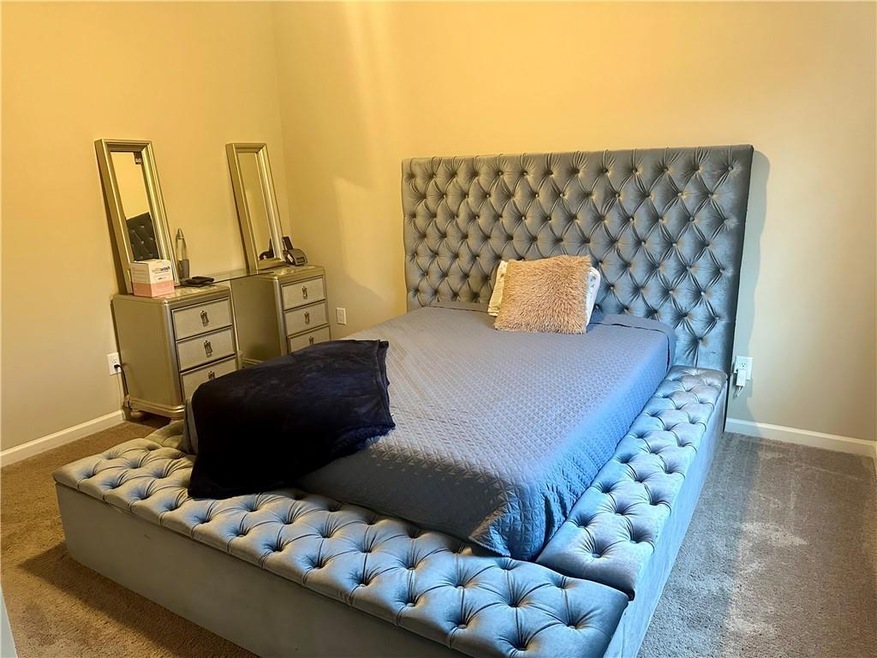 Bedroom featuring dark colored carpet