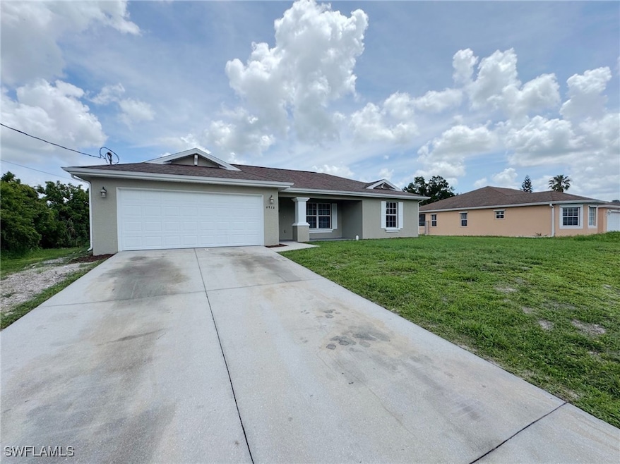 Ranch-style home with driveway, a front lawn, an a