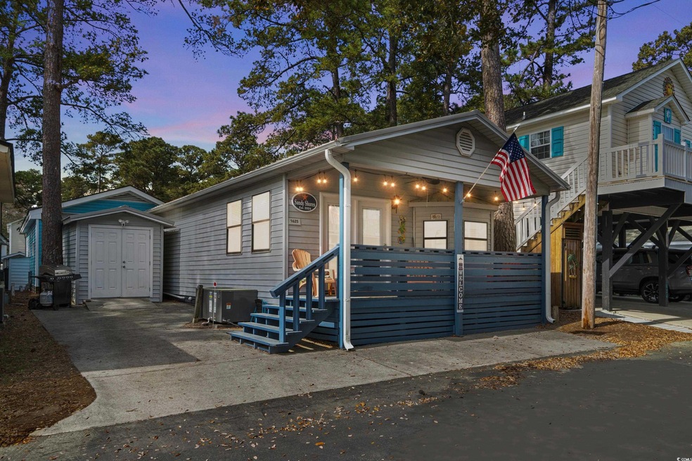 View of front of home featuring an outdoor structu