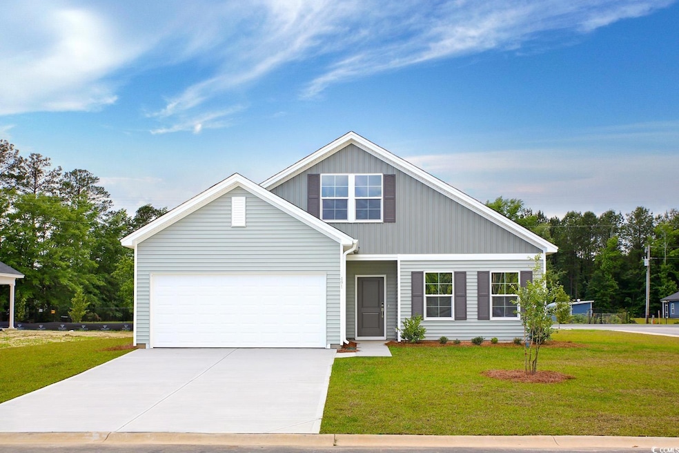 View of front facade with concrete driveway, a front lawn, and an attached garage