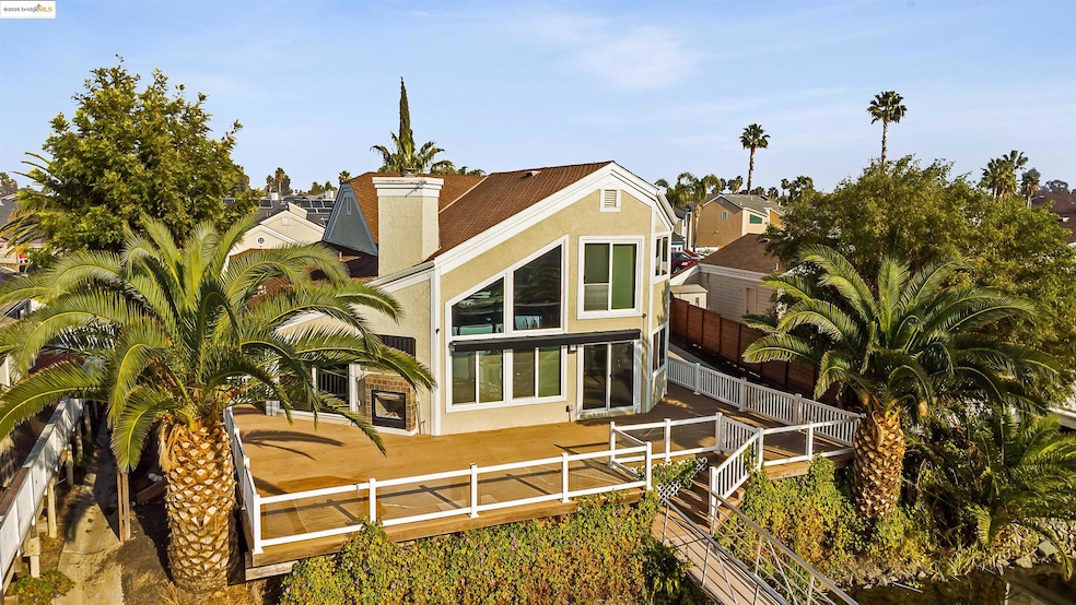 Rear view of house featuring stucco siding, a fenced backyard, a patio area, and a chimney