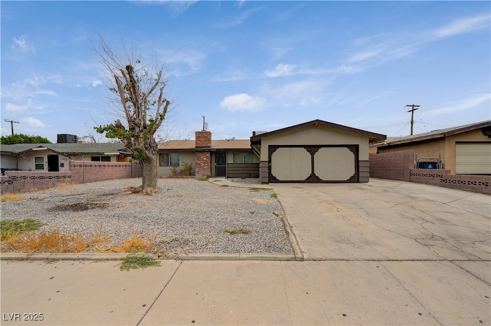 Single story home featuring concrete driveway, an attached garage, a chimney, and stucco siding