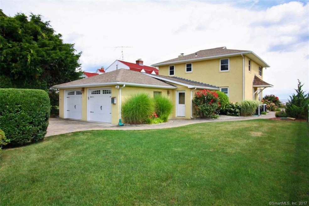 2 car garage, manicured lawn, beautiful plantings 