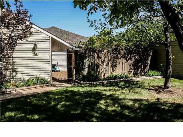 Front yard has sidewalks leading from guest parkin
