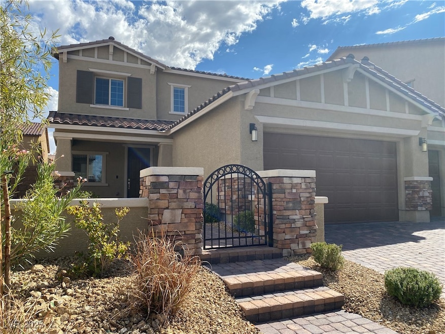 Craftsman inspired home featuring stone siding, stucco siding, a garage, decorative driveway, and a tiled roof