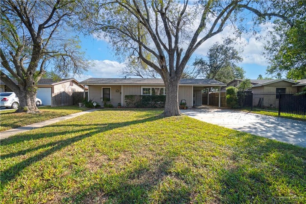 Ranch-style home featuring a front lawn and a carport