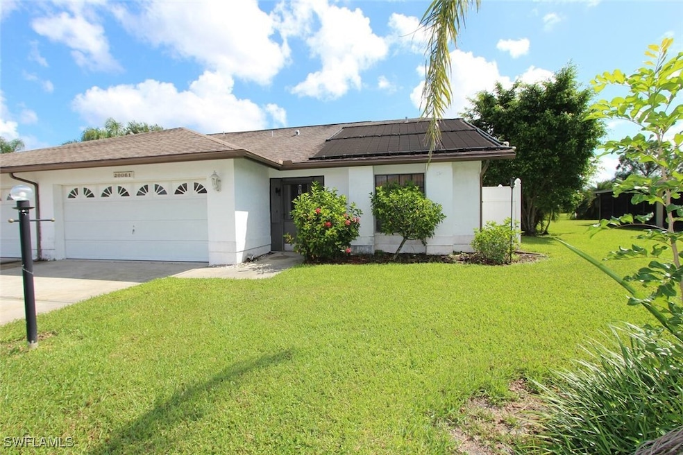 Ranch-style home featuring an attached garage, dri