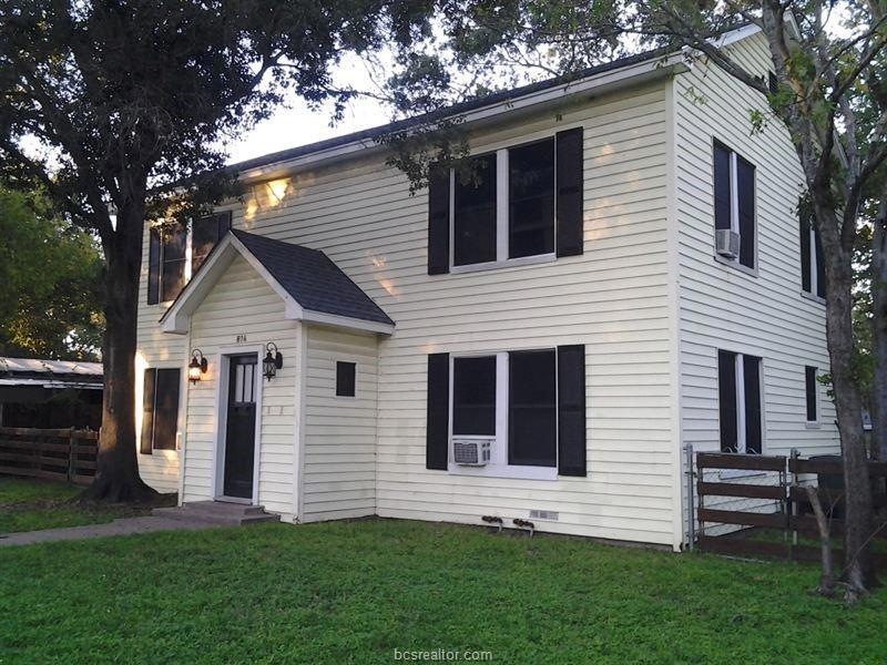 View of front of property with cooling unit and en