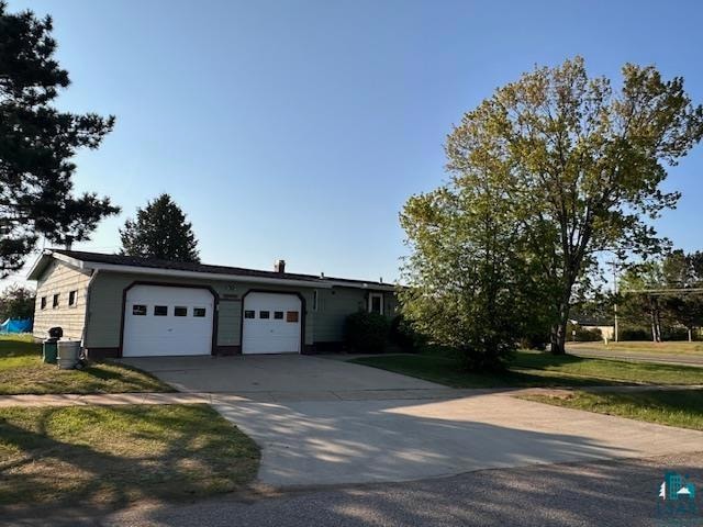 Ranch-style home with driveway and an attached garage