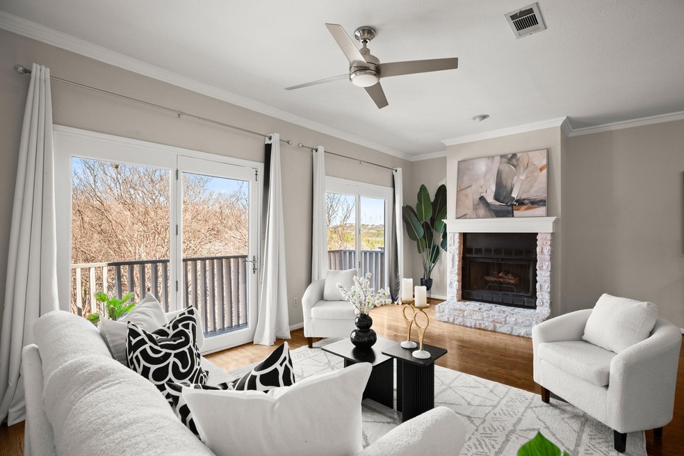 Living area featuring visible vents, a fireplace 
