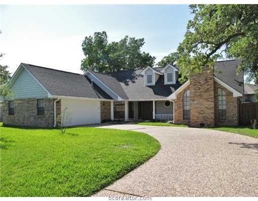 Exterior Front. Established oak trees surround thi
