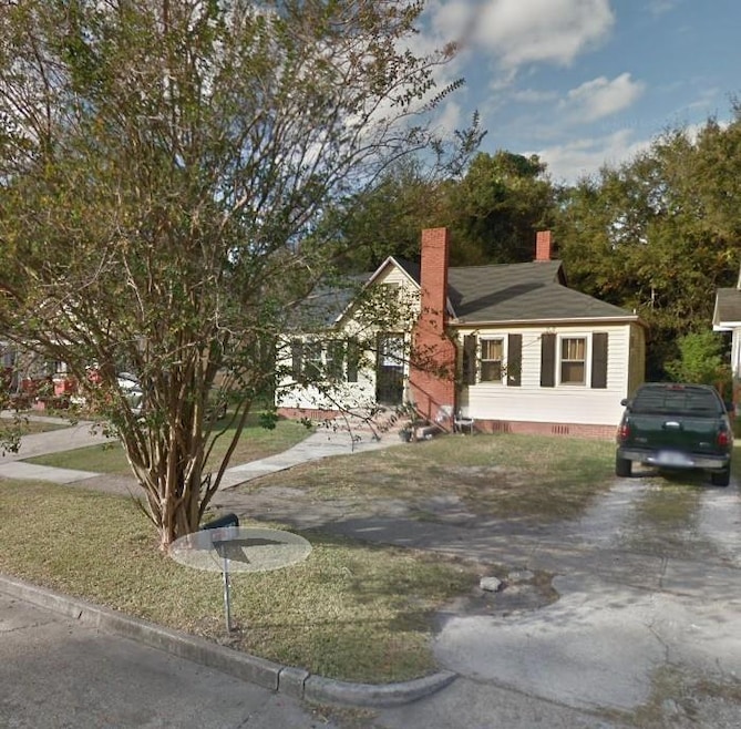 View of front facade featuring a chimney, crawl space, and a front yard