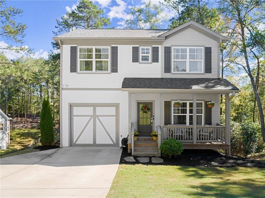 View of front facade with a porch, a front lawn, a