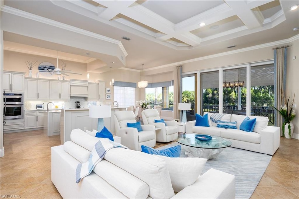 Living room featuring ornamental molding, a towering ceiling, light tile patterned flooring, beamed ceiling, and coffered ceiling