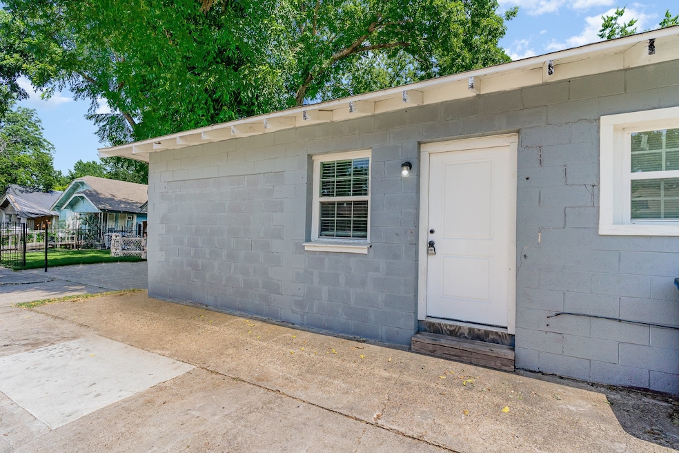 Entrance to property with concrete block siding