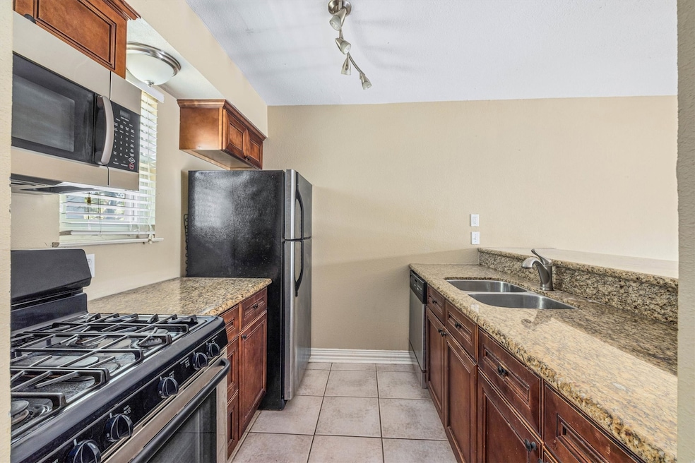 Modern kitchen with granite countertops, gas range