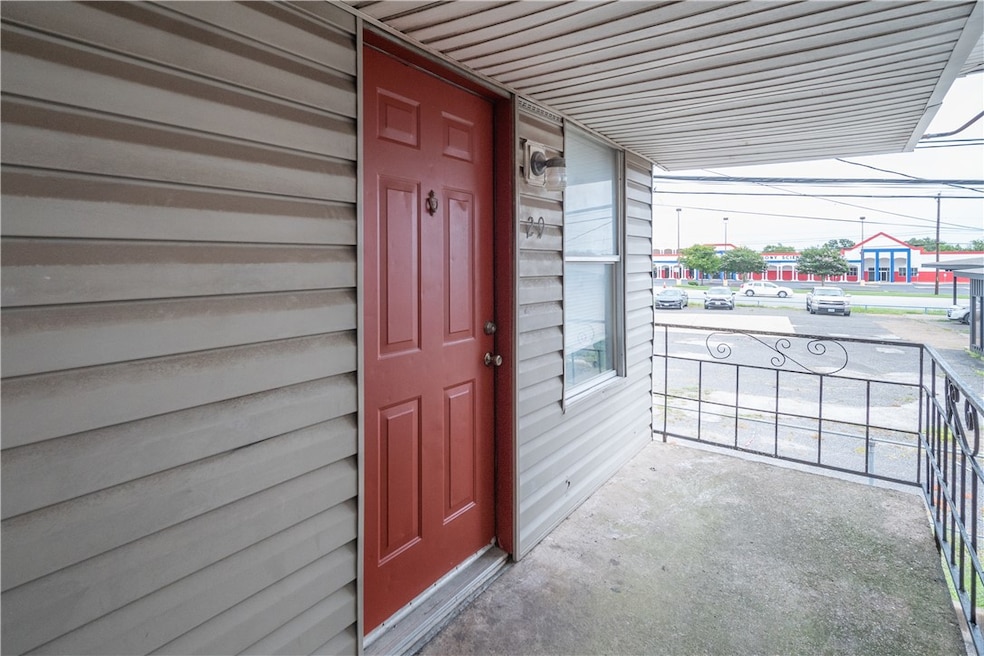 Property entrance featuring a porch and a carport