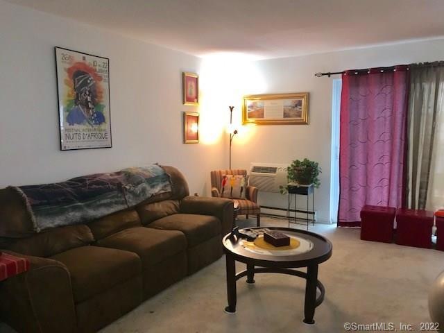 Living room with wall to wall carpet and access to