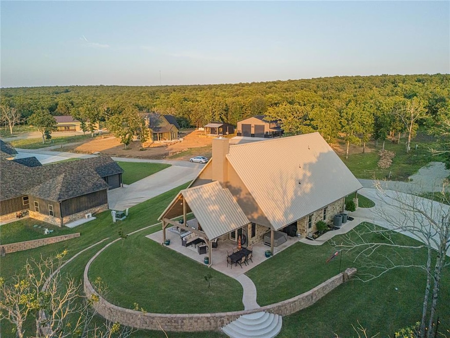 Aerial view of property and surrounding area featuring a heavily wooded area