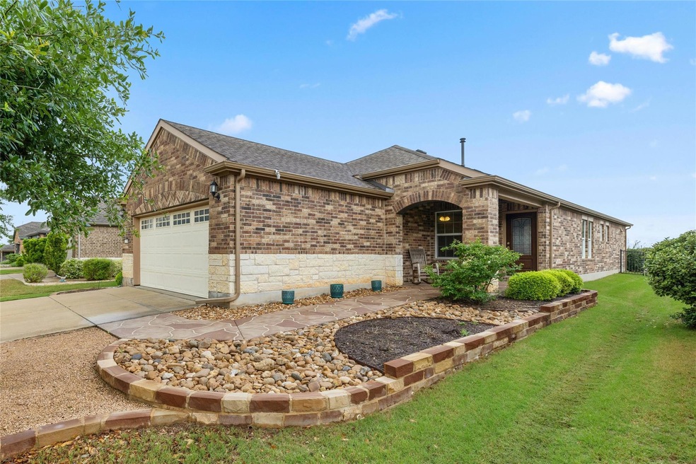 Brick and limestone exterior with professionally landscaped front yard add wonderful curb appeal.