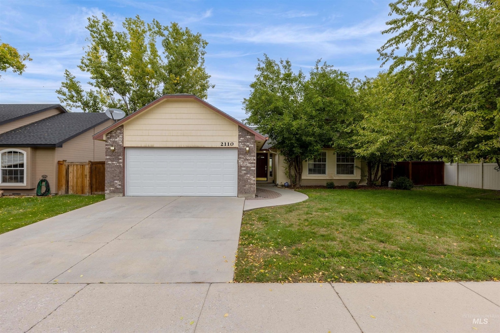 View of front of house with driveway, brick siding, and a garage