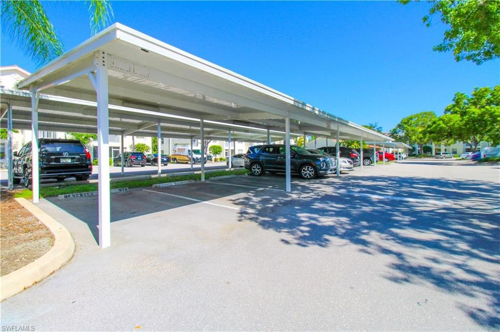 View of vehicle parking featuring a carport