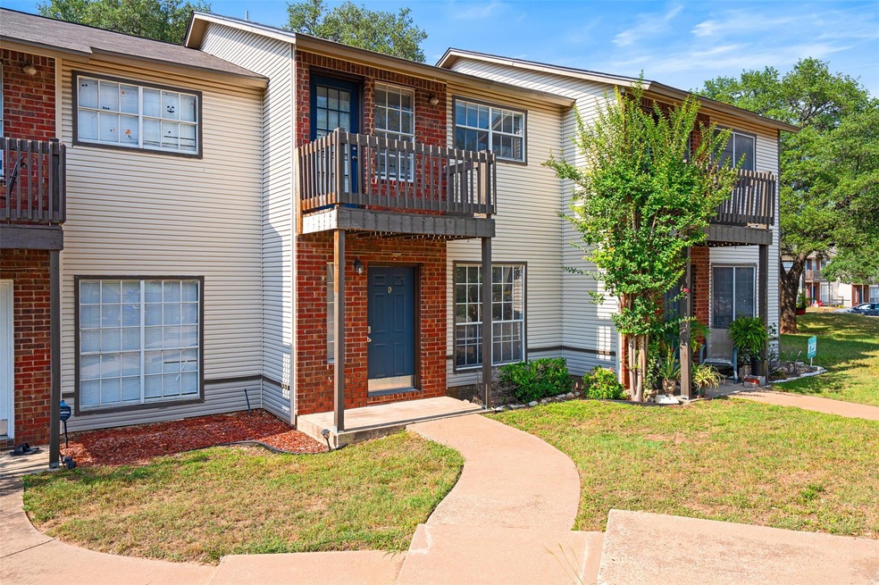 View of front of home featuring a balcony, a fron