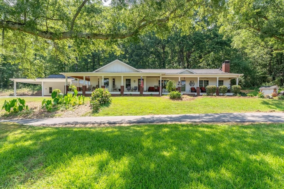 Front view of charming farmhouse with wraparound porch