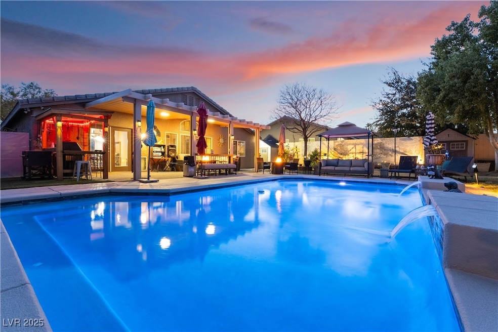 Pool at dusk featuring an outdoor living space, po