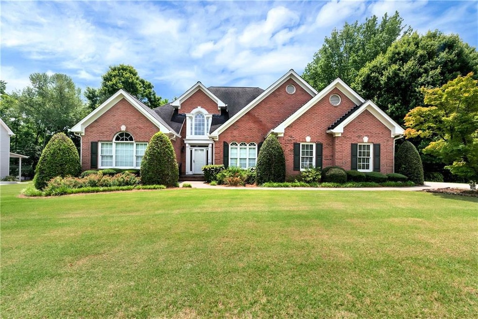 Traditional home featuring brick siding and a front yard