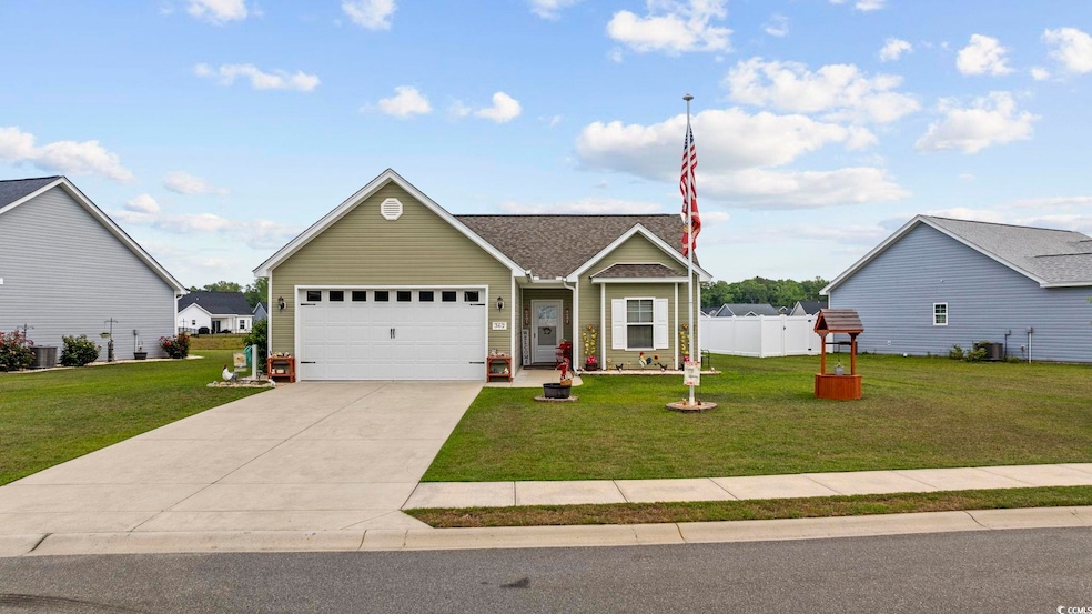 View of front of home with concrete driveway, a ga