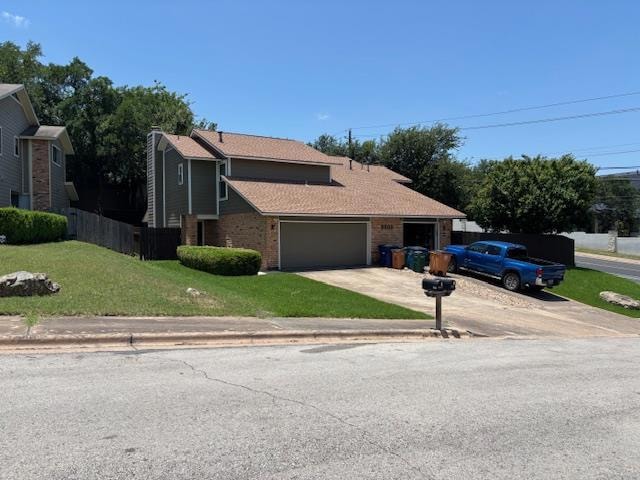 View of front of property with brick siding, concrete driveway, an attached garage, and roof with shingles