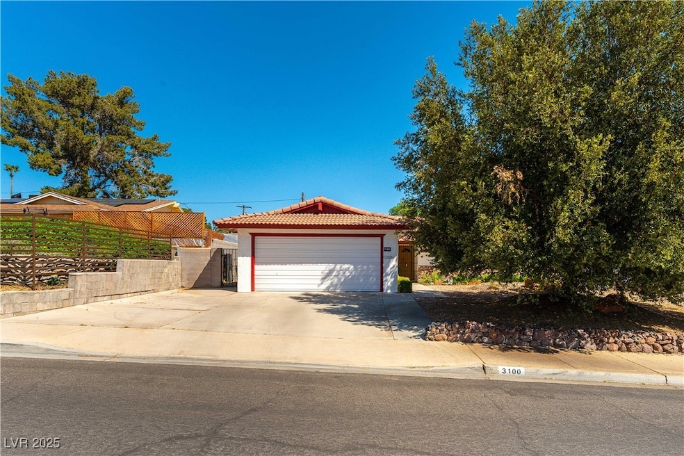 View of front of house featuring a tiled roof, a g