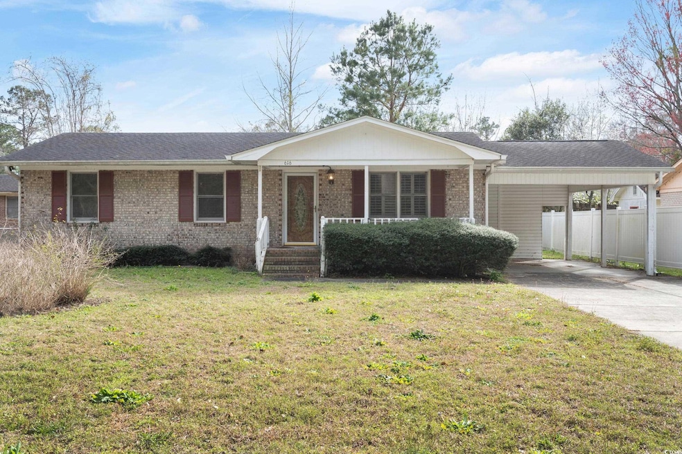 Ranch-style house with brick siding, a porch, conc
