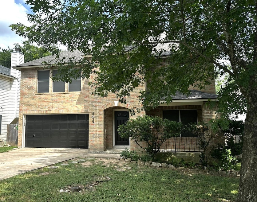 View of front facade featuring driveway, brick si
