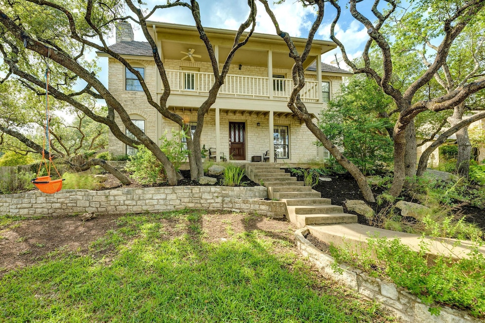 View of front facade featuring a balcony, a chimn