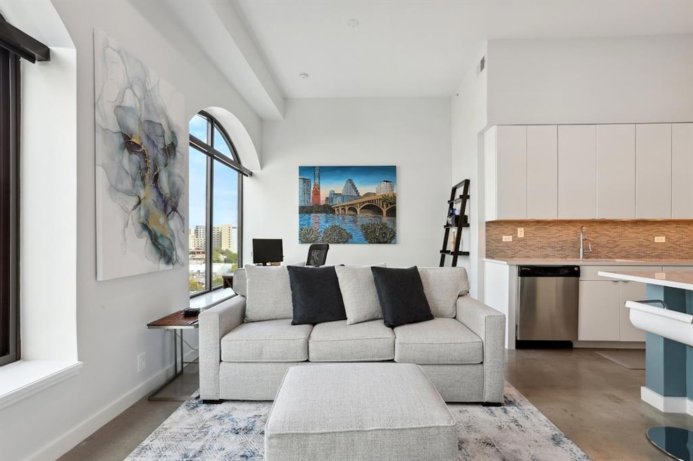 Living area with concrete floors and baseboards