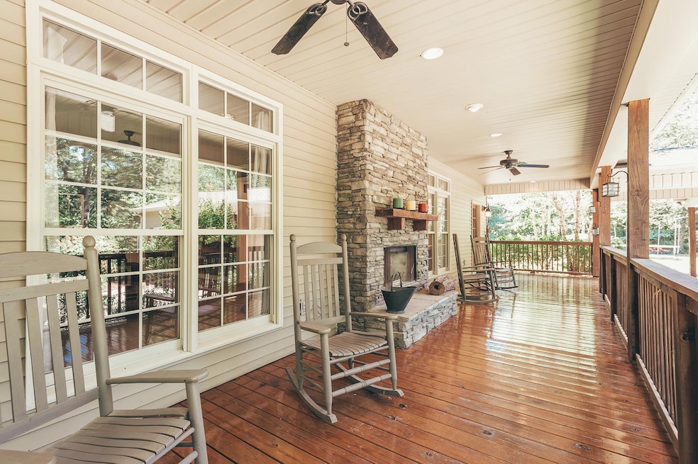 Wraparound, covered porch with wood burning fireplaces, one on each side of the porch. Whether it’s gazing at the stars, admiring the deer, or chatting with friends and family, these rocking chair porches make an everyday experience magical.