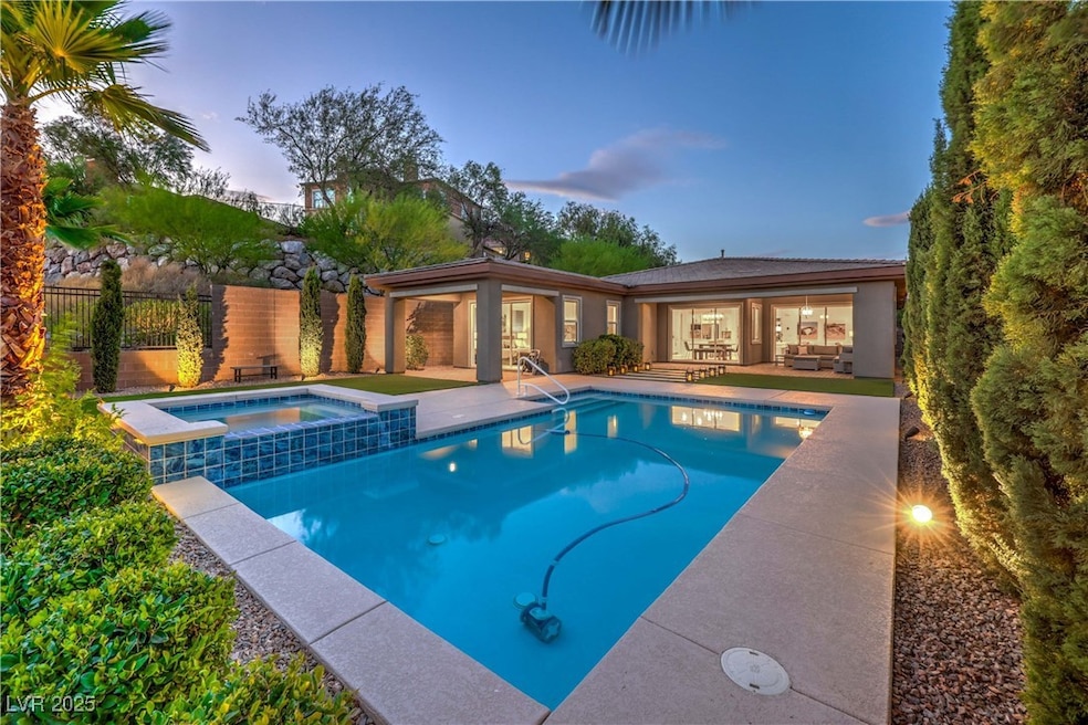 Pool at dusk with a patio area and a pool with con