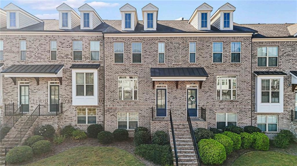 View of front of property with brick siding and stairs